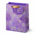 Sacchetto regalo 26 x 12 x 32 cm in carta viola con manici in nastro - motivo floreale